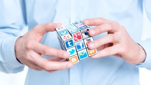 Social Media Consulting Company - Dan Karasz Consulting holding a Rubix cube of social media icons. 